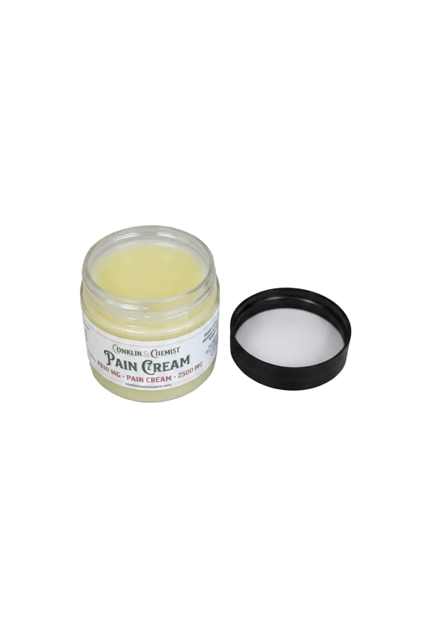 CONKLIN & CHEMIST Botanical Recovery Cream in a glass jar with a black lid, featuring a pale yellow soothing balm.